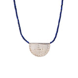 Ethically made in mexico, blue lapis lazuli beads with a Silver textured half-circle pendant 
